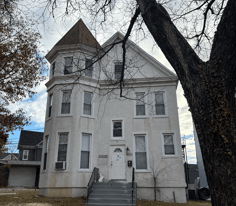 Three-story white Victorian house with turret